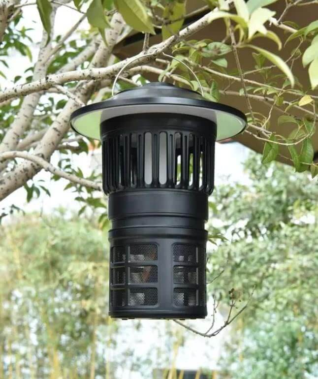 Tornado Mosquito Killer Lantern hanging from a tree, ideal for outdoor insect control in large spaces.